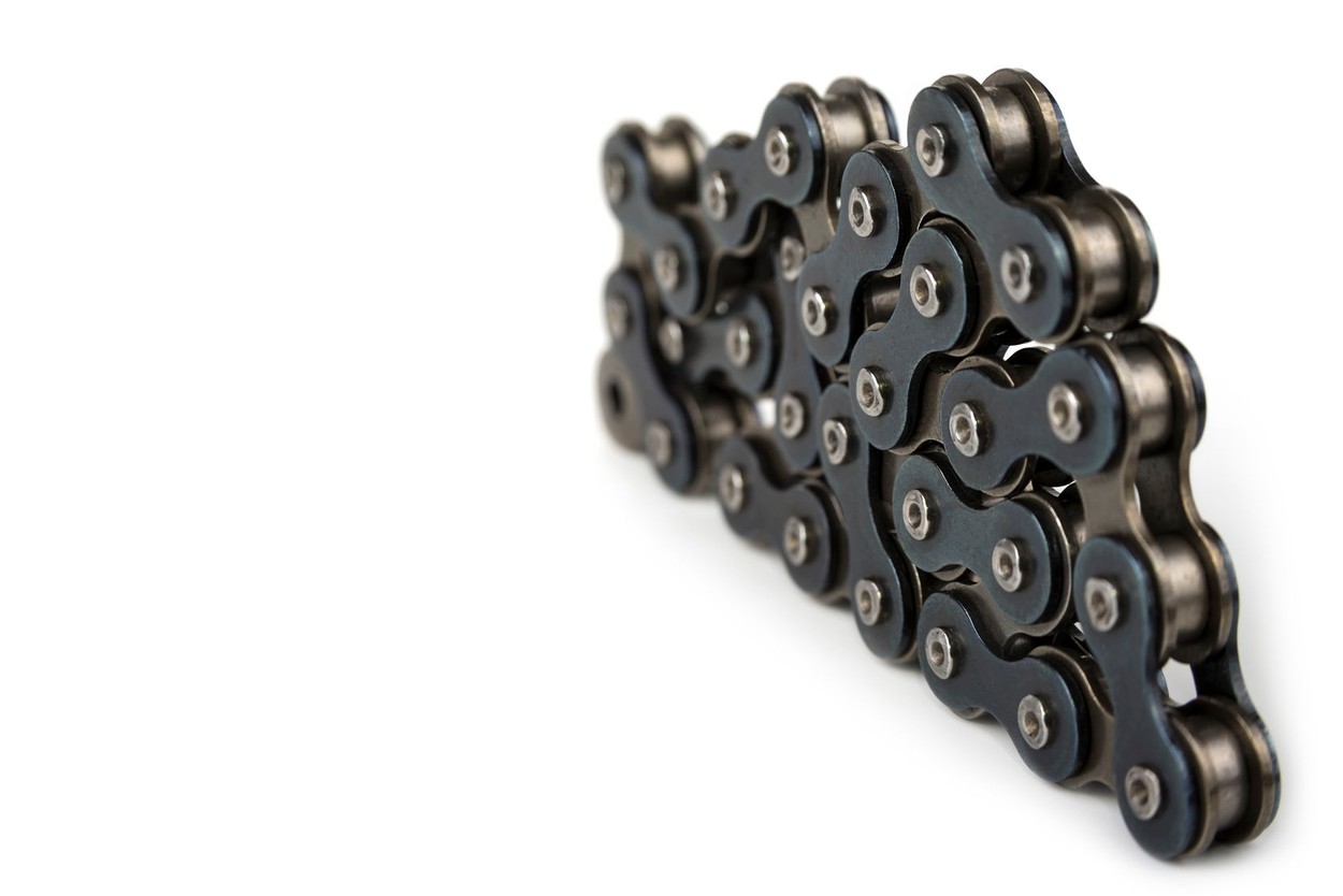 An image of a chain with black side links piled up on itself like a pyramid on a white background.
